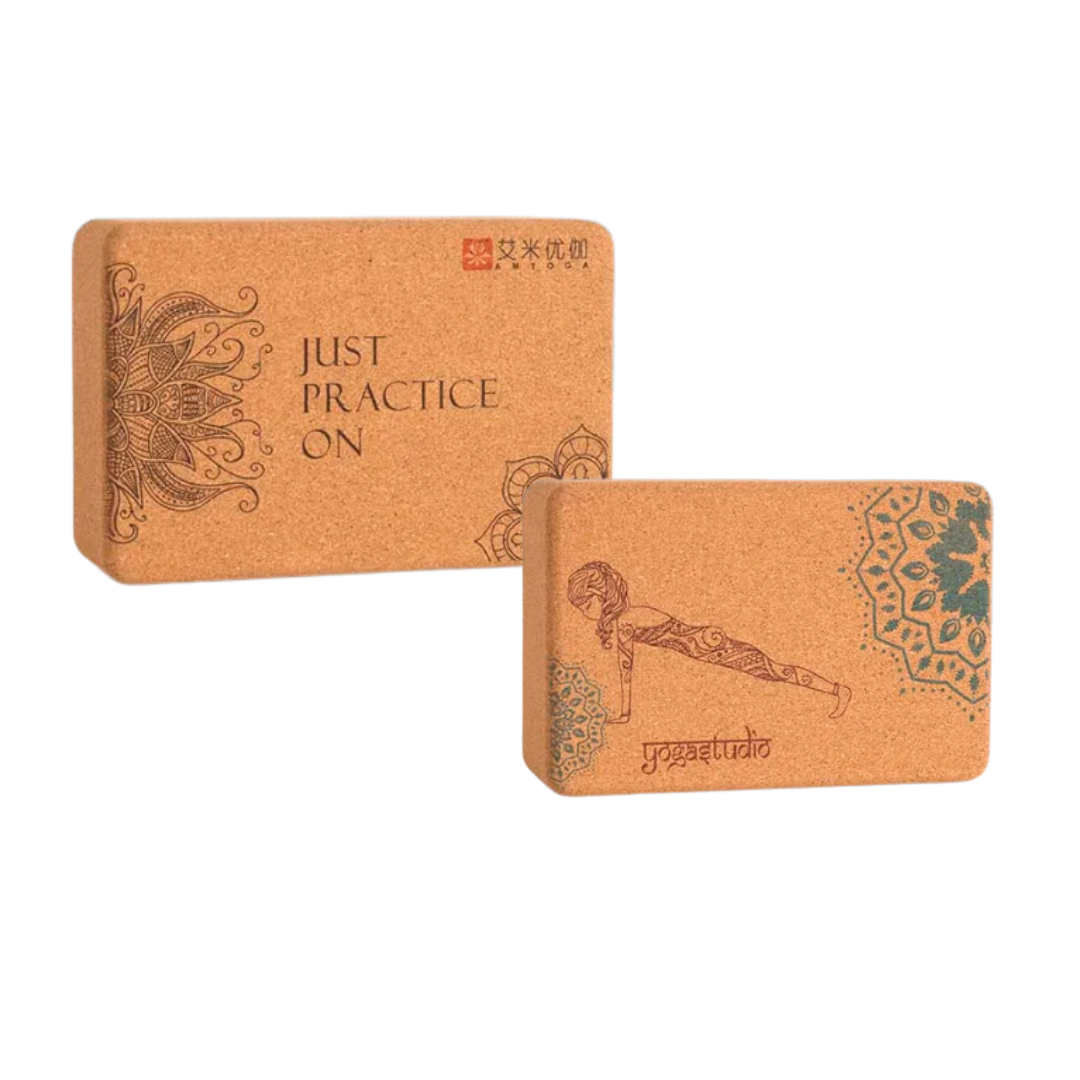 Image of the Core Block, a yoga accessory set featuring two natural cork blocks with intricate designs and the phrase 'Just Practice On.' The blocks, crafted from eco-friendly small-grain cork, are paired with a yoga strap, providing tools for stability, alignment, and flexibility. Ideal for enhancing yoga practice while promoting sustainability.