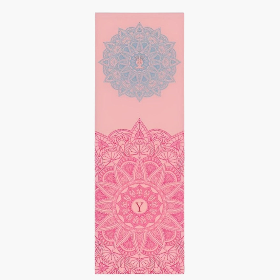 The CornerGrip Yoga Towel in the Inner Harmony design is a high-quality microfiber towel created to enhance comfort, stability, and hygiene during yoga sessions. This towel features a soft pink base with intricate mandala patterns in shades of pink and blue, symbolizing balance, harmony, and inner peace. Designed with innovative corner pockets, it securely attaches to a yoga mat to prevent slipping and bunching, ensuring a steady practice.