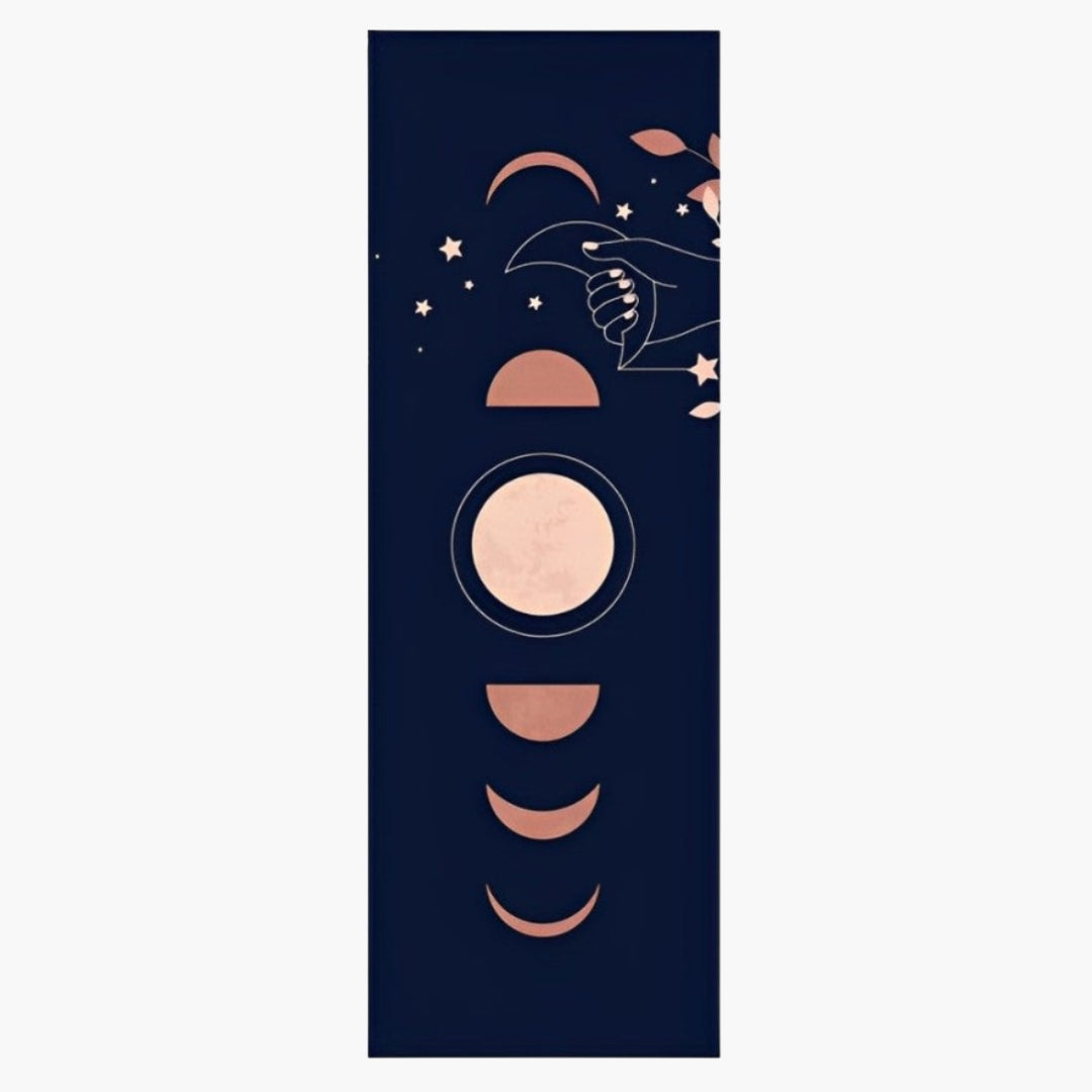 The CornerGrip Yoga Towel in the Moon Moment design is a premium microfiber towel crafted to provide stability, comfort, and hygiene during yoga practice. Featuring a deep navy blue background with elegant rose gold lunar phases, stars, and a celestial hand motif, this design symbolizes cycles, intuition, and balance. Designed with innovative corner pockets, the towel securely attaches to a yoga mat, preventing slipping and bunching for a steady and focused session.