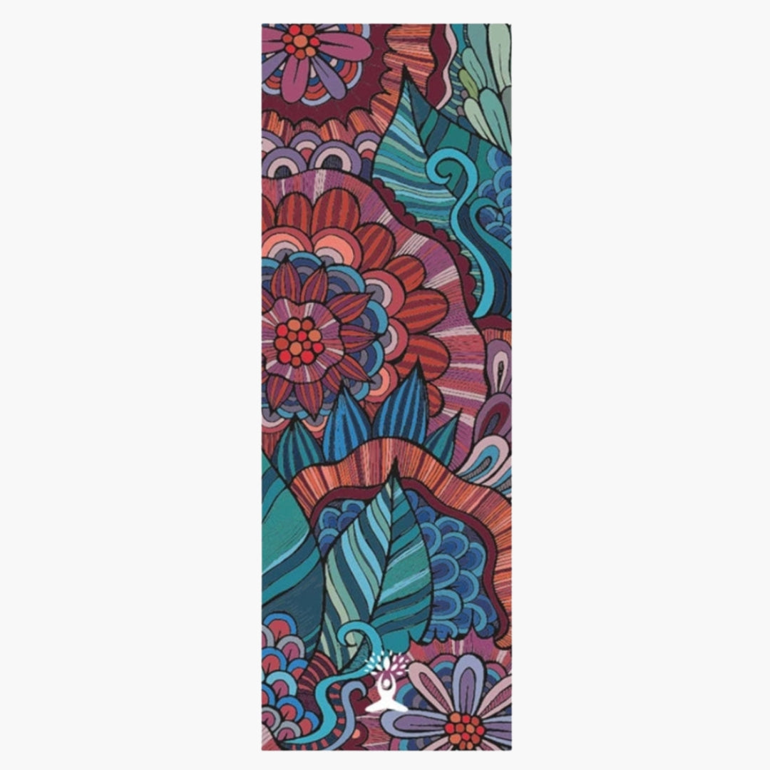 The CornerGrip Yoga Towel in the Mystic Garden design is a premium microfiber towel crafted to enhance grip, comfort, and hygiene during yoga practice. It features a vibrant floral and leaf-inspired pattern in rich tones of blue, red, and purple, evoking a sense of nature, energy, and tranquility. The innovative corner pockets securely anchor the towel to a yoga mat, preventing slipping and bunching for a distraction-free session.