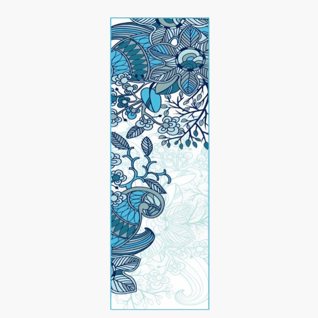 The CornerGrip Yoga Towel in the Ocean Petals design is a premium microfiber towel designed to enhance stability, comfort, and hygiene during yoga practice. It features a stunning blue floral and bird-inspired pattern, symbolizing serenity, nature, and fluidity. The innovative corner pockets securely attach the towel to a yoga mat, preventing slipping and bunching for a distraction-free session.