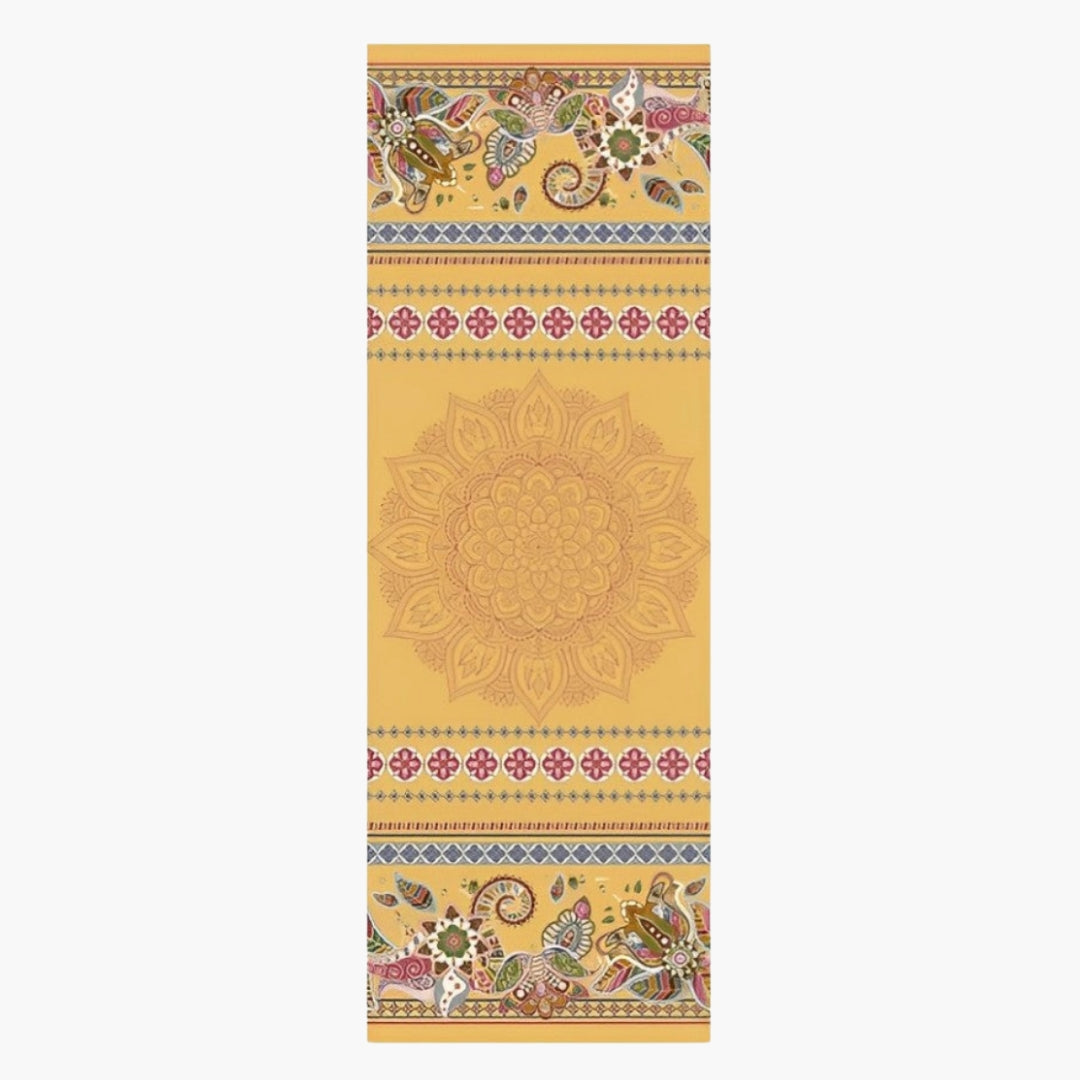 The CornerGrip Yoga Towel in the Peaceful Gold design is a high-quality microfiber towel created for stability, comfort, and hygiene during yoga practice. It features a warm golden-yellow base adorned with intricate mandala patterns, floral motifs, and decorative accents in earthy tones, evoking a sense of harmony and tradition. Designed with innovative corner pockets, it securely attaches to a yoga mat, preventing slipping and bunching for a steady and focused session.