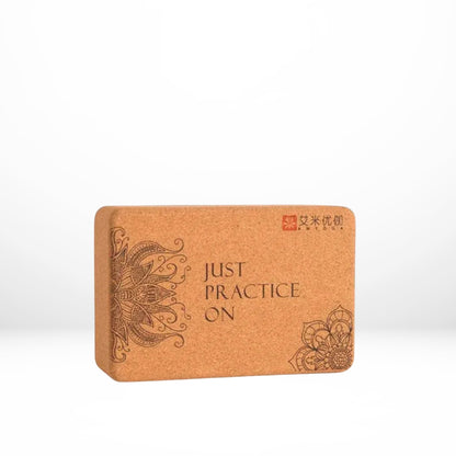 Image of the Core Block, a yoga accessory set featuring two natural cork blocks with intricate designs and the phrase 'Just Practice On.' The blocks, crafted from eco-friendly small-grain cork, are paired with a yoga strap, providing tools for stability, alignment, and flexibility. Ideal for enhancing yoga practice while promoting sustainability.