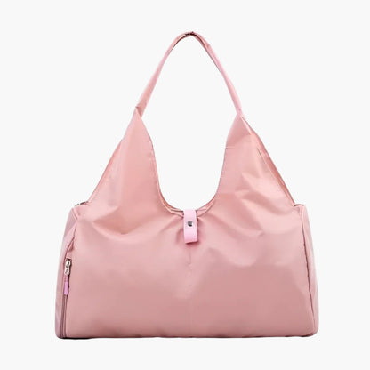 The Move Ease Gym and Yoga Bag is a stylish and functional carry-all designed for active individuals. Crafted from high-quality, water-resistant nylon, this lightweight bag provides ample space for a yoga mat, gym clothes, shoes, water bottle, and personal essentials. It features a spacious main compartment, secure internal pockets for valuables, and a dedicated side pocket for organizing smaller items.