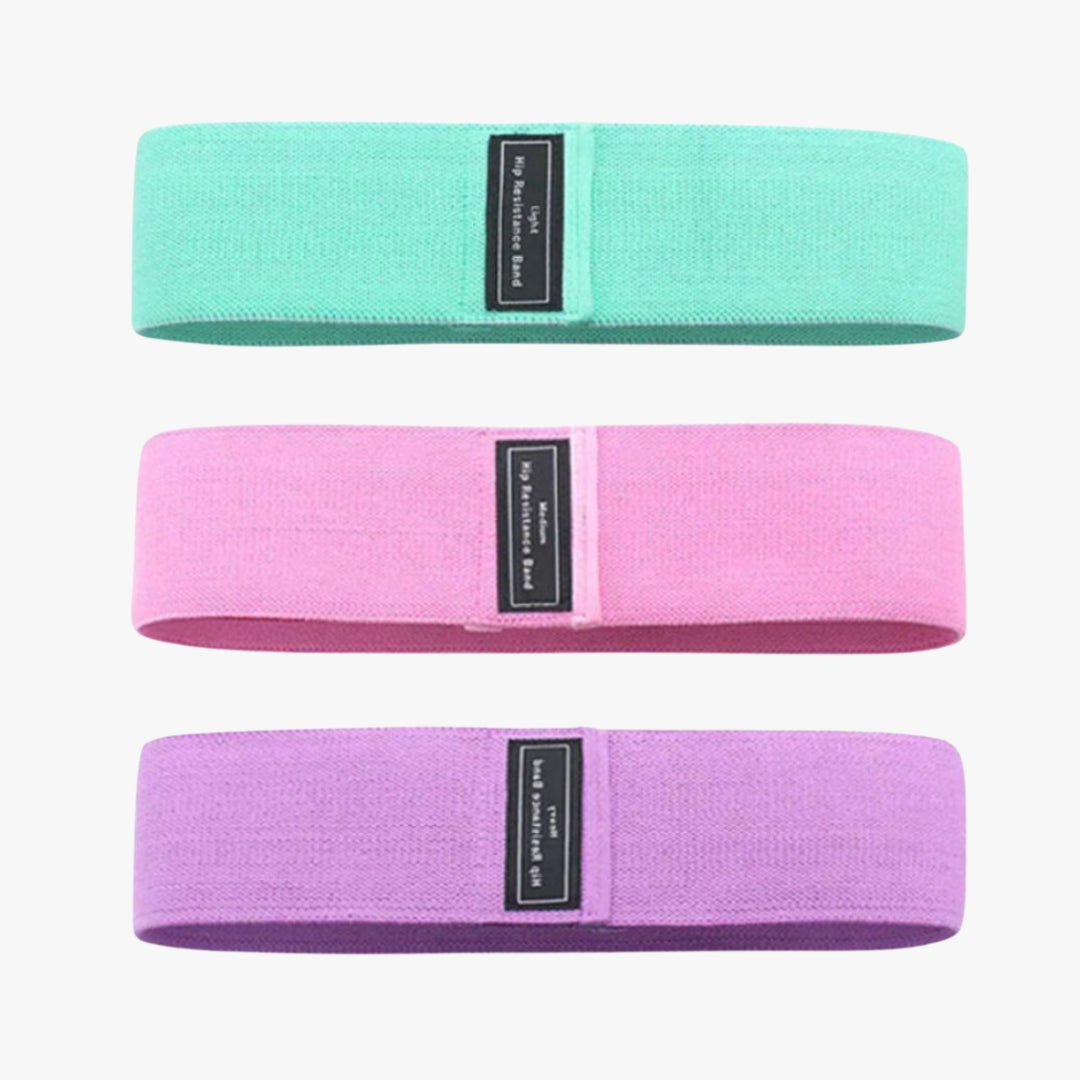 A set of three OmBand Resistance Loops in light green, pink, and purple, designed for strength training, stretching, and mobility exercises. Made from eco-friendly rubber with a non-slip surface, these resistance bands provide varying levels of support for yoga, Pilates, rehabilitation, and muscle toning. Ideal for home workouts, gym sessions, or studio use.