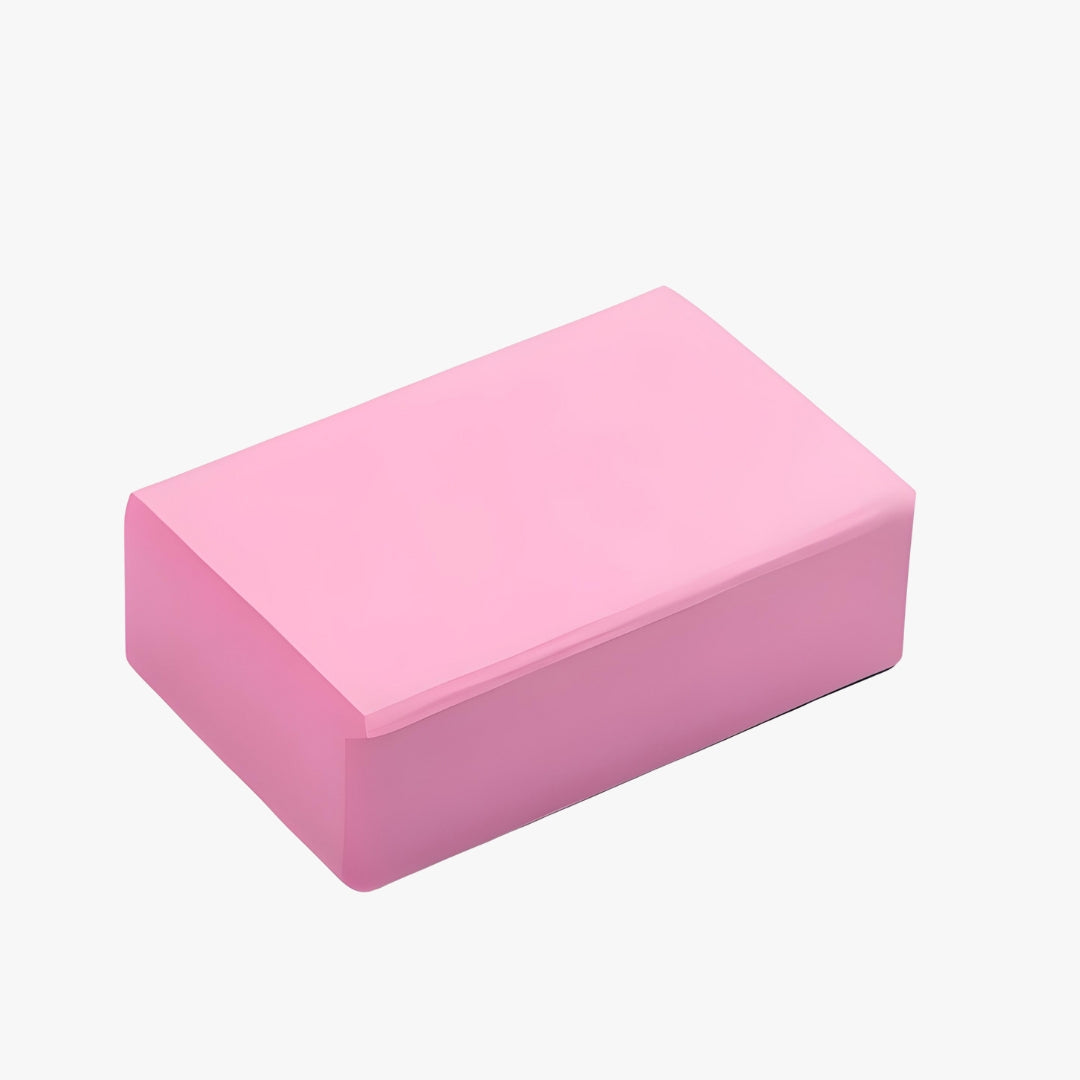 A soft pink EVA foam yoga block designed to enhance flexibility, stability, and alignment. Lightweight, durable, and with a non-slip surface, this block supports deep stretches, assists in balance poses, and provides comfort for meditation and core workouts.