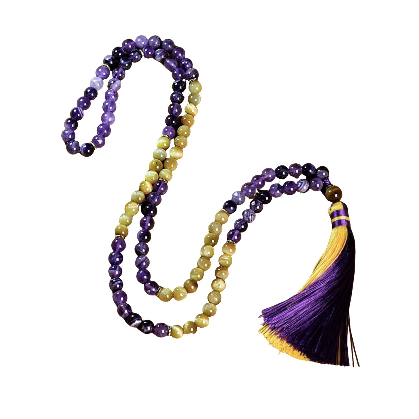 Image of the Ethereal Harmony Mala, a 108-bead meditation necklace made with purple amethyst and golden tiger eye stones. The mala features an elegant dual-color tassel in purple and yellow, coiled beautifully on a green leaf, highlighting its natural and spiritual essence. Ideal for meditation, yoga, or as a meaningful accessory.