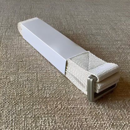 The FlexCore yoga strap in an elegant ivory shade, featuring a strong metal buckle for secure adjustments. Crafted from tightly woven, eco-friendly cotton, this durable strap provides excellent grip and support for deep stretches, flexibility training, and alignment in yoga practice.