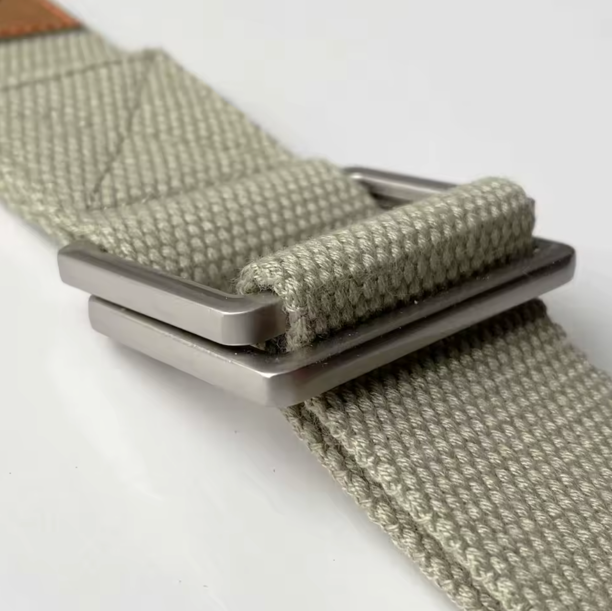 A close-up view of the FlexCore yoga strap's durable metal buckle, highlighting its sturdy double-loop design for secure adjustments. The tightly woven cotton strap in sage green ensures strength and comfort, making it ideal for deep stretches, alignment, and posture support in yoga practice.