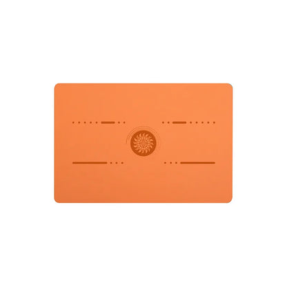 Image of the FlexPad, a rectangular yoga pad in orange, designed for targeted support and comfort during yoga or fitness exercises. The pad features a central patterned design and subtle grooves, made from eco-friendly PU natural rubber. Compact and lightweight, it provides stability and cushioning for knees, head, or other sensitive areas.