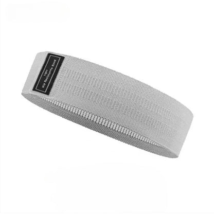 Image of the OmBand, a durable and elastic resistance band made from high-quality polyester and latex silk. Shown in light gray, this versatile band is designed for lower body exercises, providing resistance to enhance strength, flexibility, and muscle tone. Perfect for all fitness levels, it is an essential accessory for home or gym workouts.