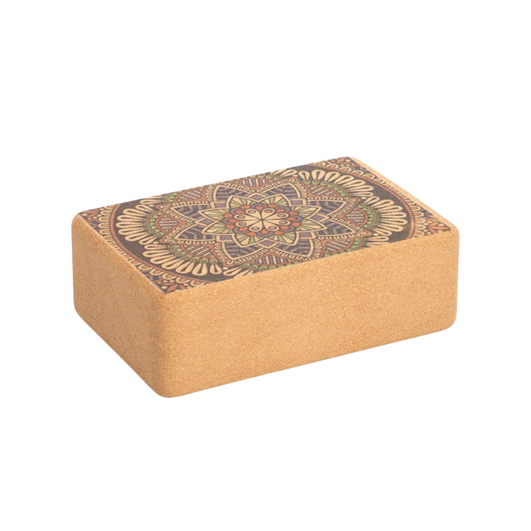 Image of a Yoga Cork Block with a beautifully engraved mandala design on the surface. Made from eco-friendly cork, this sturdy block provides stability and support for yoga poses, aiding in alignment and flexibility. Its intricate design adds a touch of elegance to functional fitness.