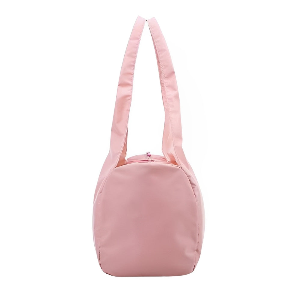 Side view of the Move Ease yoga and gym bag in soft pink. Featuring a spacious main compartment, durable handles, and a water-resistant nylon exterior, this stylish bag is perfect for carrying workout essentials, yoga gear, and travel items with ease.