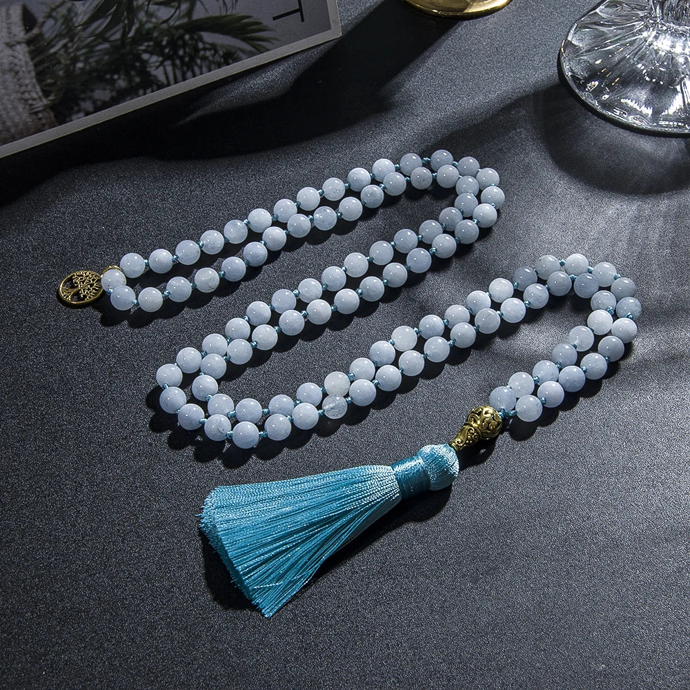 Image of the Ocean Mala, a 108-bead meditation necklace made from serene blue chalcedony stones. Featuring an elegant blue tassel and gold accents, the mala is beautifully crafted to inspire calm and balance. Its versatile design allows it to be worn as a necklace or wrapped as a bracelet, ideal for meditation or daily wear.