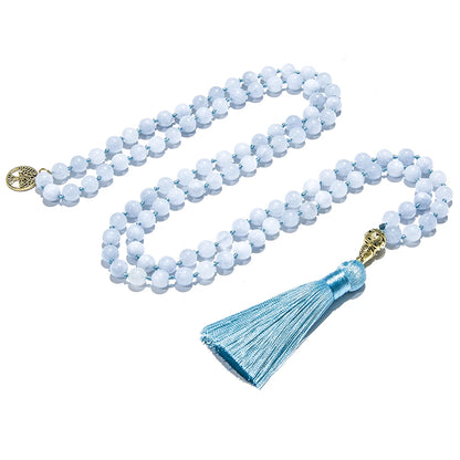 Image of the Ocean Mala, a 108-bead meditation necklace made from serene blue chalcedony stones. Featuring an elegant blue tassel and gold accents, the mala is beautifully crafted to inspire calm and balance. Its versatile design allows it to be worn as a necklace or wrapped as a bracelet, ideal for meditation or daily wear.