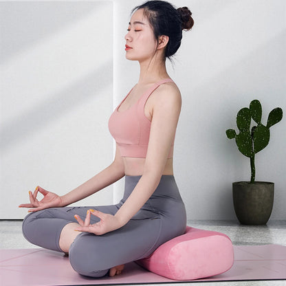 Image of the Prana Cushion, available in soft pink and gray colors. This eco-friendly yoga bolster features a sleek, rectangular design, made from mixed-density recycled foam layers for superior support and comfort. Perfect for meditation and yoga, it includes a machine-washable cover with a hidden zipper for easy maintenance.