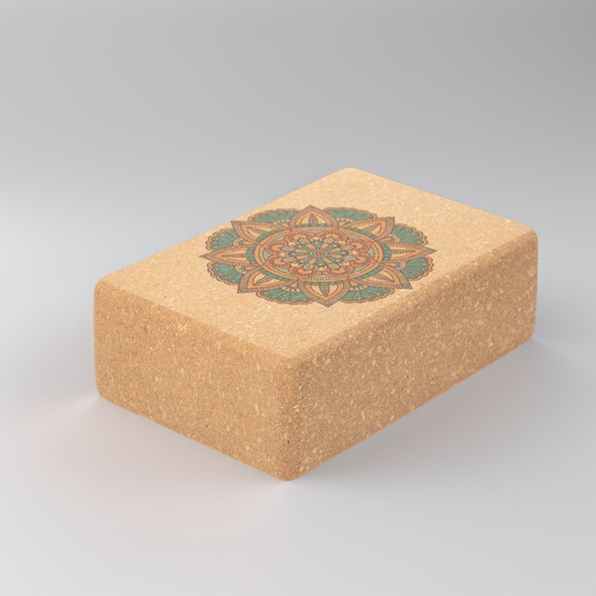 Image of a Yoga Cork Block featuring a vibrant mandala design on the top surface. This eco-friendly block provides sturdy support and stability for yoga poses, enhancing balance, flexibility, and alignment. Made from sustainable cork, it is ideal for all levels of yoga practice.