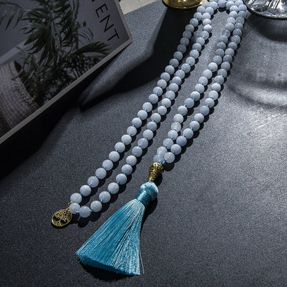 Image of the Ocean Mala, a 108-bead meditation necklace made from serene blue chalcedony stones. Featuring an elegant blue tassel and gold accents, the mala is beautifully crafted to inspire calm and balance. Its versatile design allows it to be worn as a necklace or wrapped as a bracelet, ideal for meditation or daily wear.