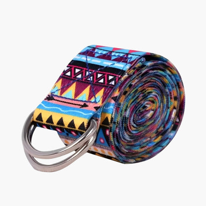 The Plentyoga StretchFlow Yoga Strap in the purple model showcases a vibrant geometric tribal-inspired pattern with shades of blue, yellow, and red. This durable and flexible strap is designed to assist with deep stretches, improve posture, and support advanced yoga poses. The sturdy D-ring buckle ensures secure adjustments, making the Plentyoga StretchFlow Yoga Strap an essential tool for both beginners and experienced yogis aiming to enhance their flexibility and alignment.