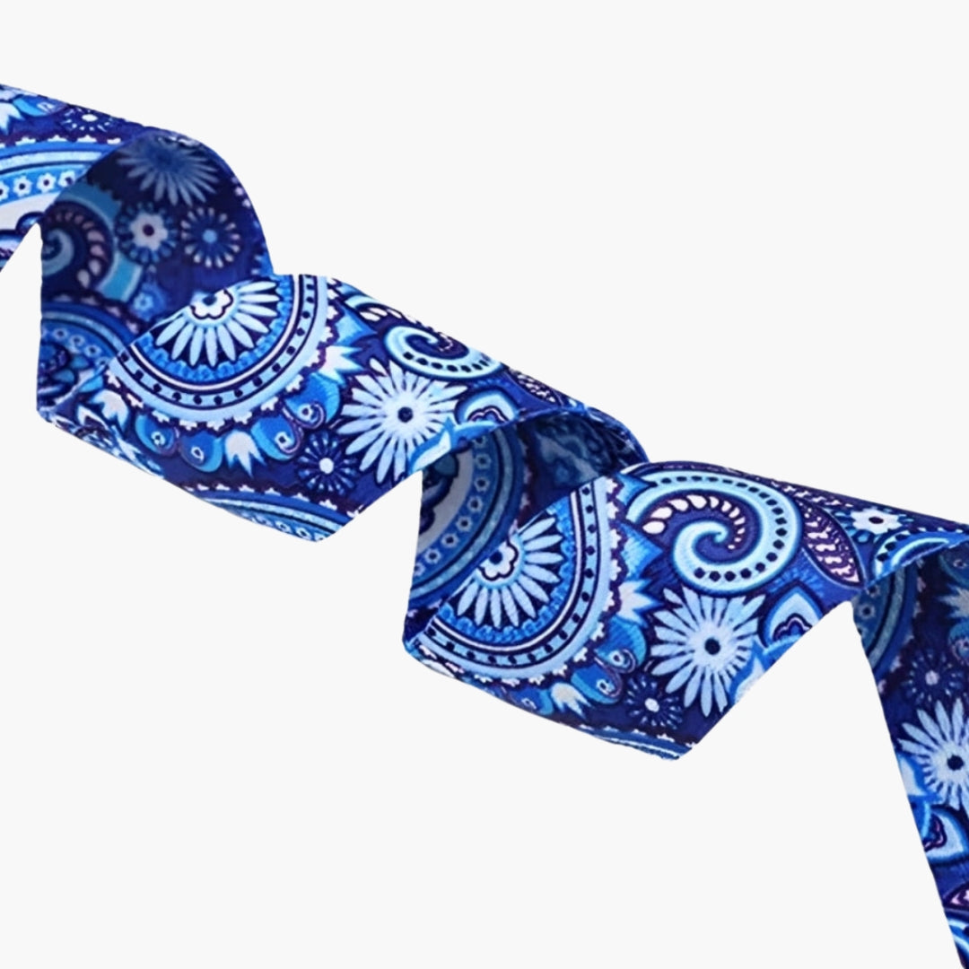 The Plentyoga StretchFlow Yoga Strap in blue features an intricate paisley and floral design in deep blue and white tones, bringing a touch of elegance to your practice. Made from a strong cotton blend, this strap offers superior grip and support for deepening stretches and improving posture. With its adjustable D-ring buckle, the Plentyoga StretchFlow Yoga Strap ensures a secure fit, making it an essential tool for yogis of all levels looking to enhance flexibility and alignment.