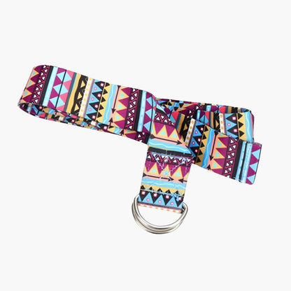 The Plentyoga StretchFlow Yoga Strap in purple features a vibrant tribal-inspired pattern, adding a stylish touch to your practice. Made from a durable cotton blend, this strap provides secure grip and flexibility support with its sturdy D-ring buckle for easy adjustments. Measuring 183 cm in length, it helps enhance flexibility, deepen stretches, and maintain proper posture in various yoga and fitness routines.