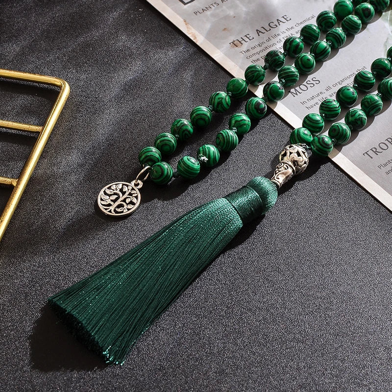 Image of the Serenity Stone Mala, a 108-bead meditation necklace crafted from vibrant green malachite stones. Featuring a hand-knotted design for durability and an elegant dark green tassel, the mala symbolizes protection and personal transformation. Perfect for meditation, yoga, or as a meaningful daily accessory.