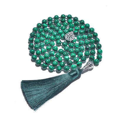 Image of the Serenity Stone Mala, a 108-bead meditation necklace crafted from vibrant green malachite stones. Featuring a hand-knotted design for durability and an elegant dark green tassel, the mala symbolizes protection and personal transformation. Perfect for meditation, yoga, or as a meaningful daily accessory.