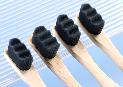 Image of PureEarth toothbrushes featuring natural bamboo handles and black bristles. These eco-friendly toothbrushes are designed to reduce plastic waste while providing a deep and effective clean. Displayed in a minimalist setting, they are perfect for those seeking a sustainable oral care solution.