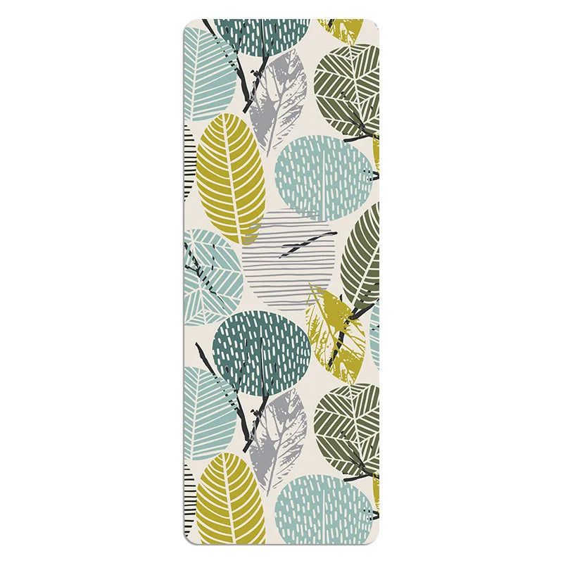 Image of the Travel Ease Yoga Mat in the green design, featuring a pattern of colorful leaves in shades of green, blue, and yellow. Made from a suede and rubber blend, this ultra-thin, foldable mat is perfect for travel, offering a non-slip surface and stylish look for yoga and fitness routines.