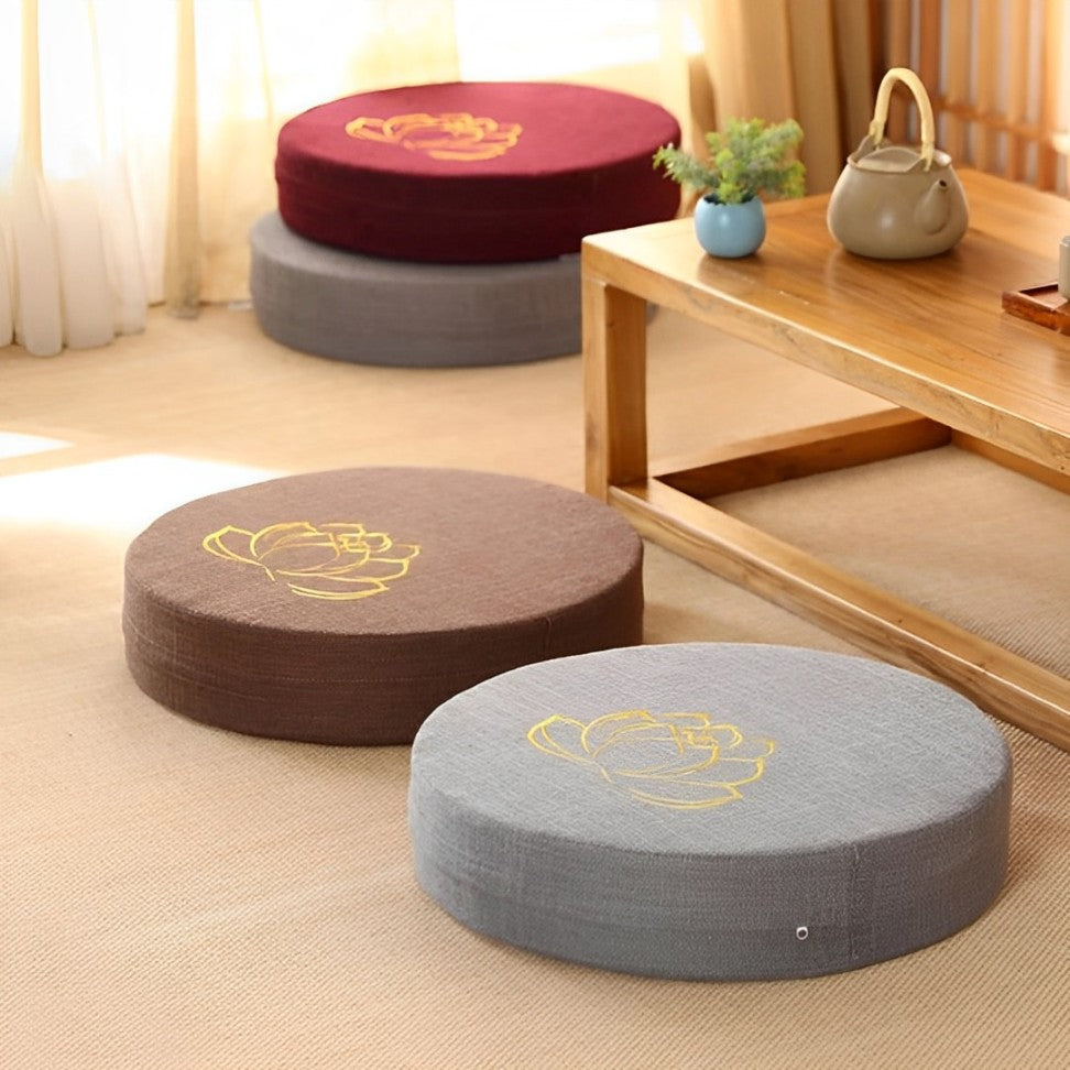 Image of the ZenBase Meditation Cushions in gray, brown, and red, each featuring a minimalist lotus design. These durable cushions provide firm support for meditation and yoga, combining Japanese-inspired tatami aesthetics with practicality. Compact, washable, and perfect for enhancing mindfulness practices.